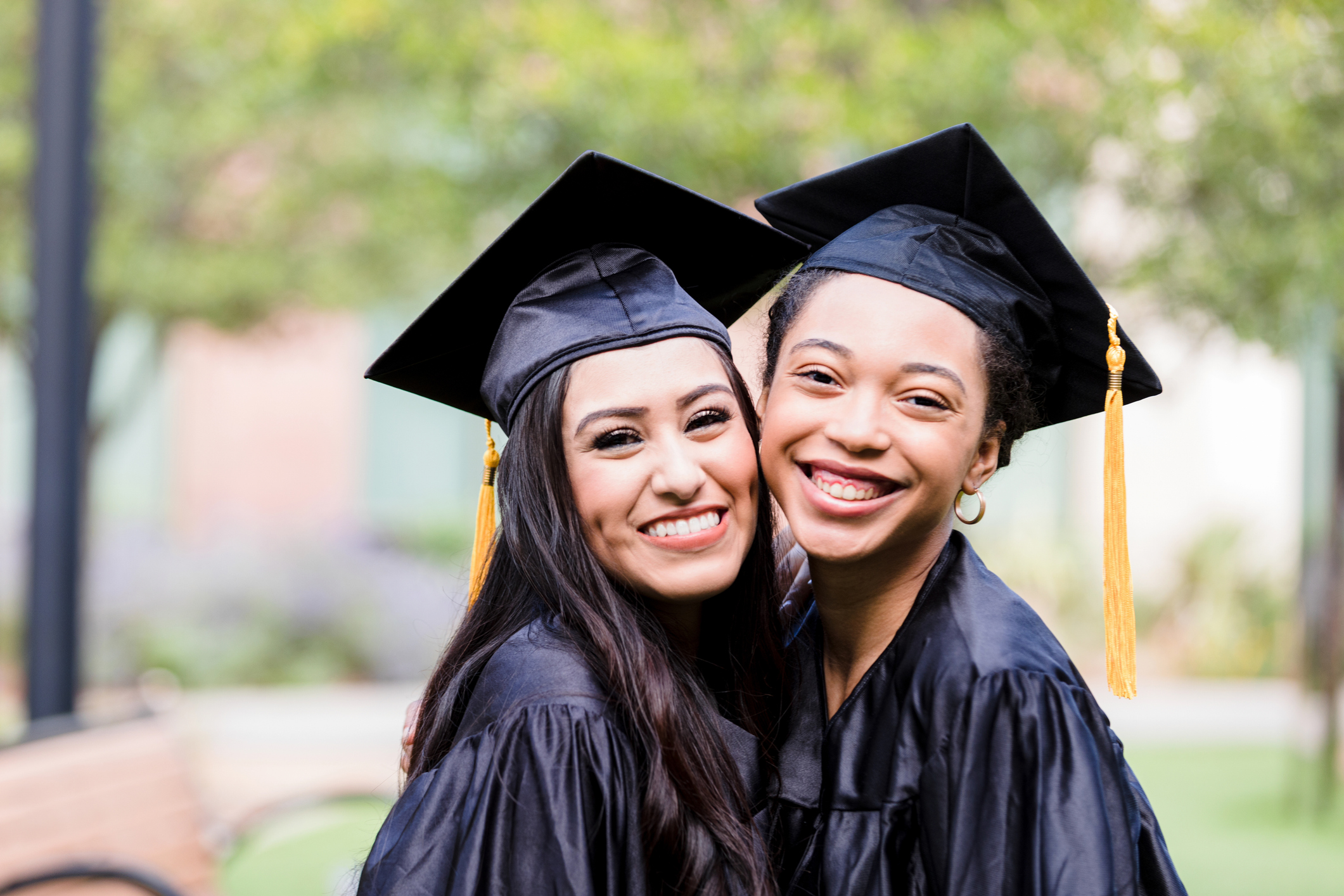 Two female friends pose for photo after graduation